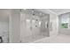 Bathroom featuring an elegant shower with large glass enclosure, white marble, and dual shower heads at 28512 Picana Ln, Wesley Chapel, FL 33543