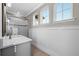 Bright bathroom featuring a vanity, shower, and wainscoting detail on the walls at 28512 Picana Ln, Wesley Chapel, FL 33543