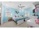 bedroom with two twin beds and a light blue accent wall at 28512 Picana Ln, Wesley Chapel, FL 33543