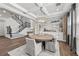 Elegant dining room with stylish chandelier, brick accents, and convenient access to the staircase at 28512 Picana Ln, Wesley Chapel, FL 33543