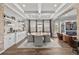 Dining area with coffered ceiling, modern lighting, and views into the living area at 28512 Picana Ln, Wesley Chapel, FL 33543