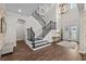 Grand foyer with soaring ceilings, wood floors, elegant staircase and beautiful lighting at 28512 Picana Ln, Wesley Chapel, FL 33543