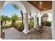Inviting front porch with rocking chairs, brick pavers and beautiful landscaping at 28512 Picana Ln, Wesley Chapel, FL 33543