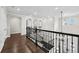 Upper level hallway with arched doorways, decorative molding, and views of the foyer at 28512 Picana Ln, Wesley Chapel, FL 33543