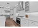 Bright kitchen with stainless steel appliances, white cabinetry, and an elegant range hood at 28512 Picana Ln, Wesley Chapel, FL 33543