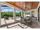 Covered lanai offering outdoor dining and relaxing by a pool and scenic backyard at 28512 Picana Ln, Wesley Chapel, FL 33543