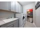 Well-organized laundry room featuring modern appliances and ample storage space at 28512 Picana Ln, Wesley Chapel, FL 33543
