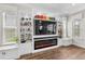 Bright living area with a modern fireplace, custom built-ins, and elegant shelving at 28512 Picana Ln, Wesley Chapel, FL 33543