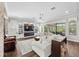 Spacious living room featuring a fireplace, built-in shelving, and large windows at 28512 Picana Ln, Wesley Chapel, FL 33543