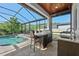 Poolside outdoor kitchen and bar area, perfect for entertaining guests at 28512 Picana Ln, Wesley Chapel, FL 33543