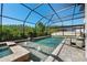 Screened in pool with fountains and hot tub overlooking lush green space at 28512 Picana Ln, Wesley Chapel, FL 33543
