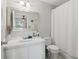 Bathroom featuring a single sink vanity, large mirror, and a shower with a curtain at 2914 W Gandy Blvd # C, Tampa, FL 33611
