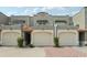 Charming townhouse with a two-car garage, elegant tile roof, and nicely manicured landscaping at 2914 W Gandy Blvd # C, Tampa, FL 33611