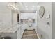 Bright kitchen featuring marble countertop, white cabinetry, modern lighting, and stainless steel appliances at 2914 W Gandy Blvd # C, Tampa, FL 33611