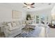 Comfortable living room featuring a large sectional sofa, a blue rug, and a view of the outdoor patio at 2914 W Gandy Blvd # C, Tampa, FL 33611
