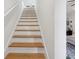 Staircase with wooden steps and white risers leading to the upper level of the house at 2914 W Gandy Blvd # C, Tampa, FL 33611
