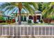 Charming bungalow with mature palm tree, white picket fence, and lush landscaping at 2921 3Rd S Ave, St Petersburg, FL 33712