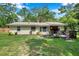 Expansive backyard with mature trees, a deck, and lush green lawn. Enjoy outdoor living at 316 Jenkins Ave, Brooksville, FL 34604