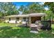 Beautiful backyard with a wooden deck, lush plants, and well-manicured lawn, creating a private retreat at 316 Jenkins Ave, Brooksville, FL 34604