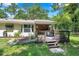 Charming backyard with a wooden deck, lush landscaping, and a serene outdoor setting, perfect for relaxation at 316 Jenkins Ave, Brooksville, FL 34604