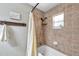 Bathroom featuring a shower-tub combination with neutral tile and a shower curtain at 316 Jenkins Ave, Brooksville, FL 34604
