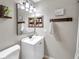 Bathroom with updated vanity, framed mirror, and neutral paint at 316 Jenkins Ave, Brooksville, FL 34604