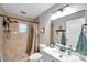 Well-lit bathroom featuring tiled shower, stylish vanity, and updated fixtures for a clean and functional space at 316 Jenkins Ave, Brooksville, FL 34604