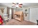 Charming bedroom featuring a tented bed, ceiling fan, and neutral color scheme for a cozy and playful atmosphere at 316 Jenkins Ave, Brooksville, FL 34604