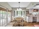 Bright breakfast nook with bay window offers charming view and access to the backyard at 316 Jenkins Ave, Brooksville, FL 34604