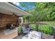Cozy covered deck area with wood paneling, ceiling fan, and outdoor seating, overlooking a green yard at 316 Jenkins Ave, Brooksville, FL 34604