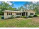 Charming single-story home with a well-maintained lawn and cozy shutters at 316 Jenkins Ave, Brooksville, FL 34604