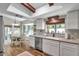 Updated kitchen features a breakfast nook, stainless steel appliances, and wood-look tile flooring at 316 Jenkins Ave, Brooksville, FL 34604