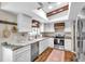 Updated kitchen with white cabinets, stainless steel appliances, and hardwood flooring at 316 Jenkins Ave, Brooksville, FL 34604