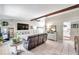 Spacious living room boasts a stone fireplace, exposed beam, and seamless flow to other living spaces at 316 Jenkins Ave, Brooksville, FL 34604