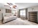 Comfortable main bedroom features plush carpeting, a ceiling fan, and natural light at 316 Jenkins Ave, Brooksville, FL 34604