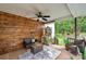 Comfortable covered patio area with wood paneling, ceiling fan, and view of the backyard at 316 Jenkins Ave, Brooksville, FL 34604