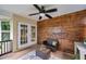 Covered patio featuring wood accent wall and elegant French doors leading to the dining room at 316 Jenkins Ave, Brooksville, FL 34604