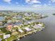 Aerial view of waterfront neighborhood showcasing community layout, boating access, and nearby amenities at 3285 Minnow Creek Dr, Hernando Beach, FL 34607