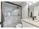 Bathroom featuring tiled shower with black hardware and glass doors at 3285 Minnow Creek Dr, Hernando Beach, FL 34607