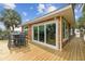 Inviting back deck with outdoor seating and views of lush palms and surrounding nature at 3285 Minnow Creek Dr, Hernando Beach, FL 34607