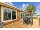 Inviting back deck with outdoor seating and views of lush palms and surrounding nature at 3285 Minnow Creek Dr, Hernando Beach, FL 34607