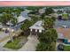 Waterfront home featuring a metal roof, mature palms, and elevated construction providing picturesque views at 3285 Minnow Creek Dr, Hernando Beach, FL 34607