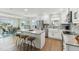 Open concept floor plan featuring kitchen with island seating, stainless appliances, and tile backsplash at 3285 Minnow Creek Dr, Hernando Beach, FL 34607