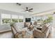 Bright living room featuring neutral furniture, ceiling fans, and view of the water at 3285 Minnow Creek Dr, Hernando Beach, FL 34607