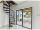 Spacious room with spiral staircase and sliding glass doors out to the canal at 3285 Minnow Creek Dr, Hernando Beach, FL 34607