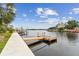 This waterfront property features a private dock on a calm waterway under a sunny sky at 3285 Minnow Creek Dr, Hernando Beach, FL 34607