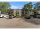 Three story condo building with parking, mature trees, and balconies, offering serene outdoor living at 3325 Bayshore Blvd # C36, Tampa, FL 33629
