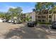 Condominium exterior featuring balconies, parking, mature trees, and well-maintained landscaping at 3325 Bayshore Blvd # C36, Tampa, FL 33629