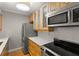 Modern kitchen with stainless steel appliances, quartz countertops, and wooden cabinets at 3325 Bayshore Blvd # C36, Tampa, FL 33629