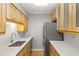 Compact kitchen with wood cabinets, stainless steel appliances, and quartz countertops at 3325 Bayshore Blvd # C36, Tampa, FL 33629